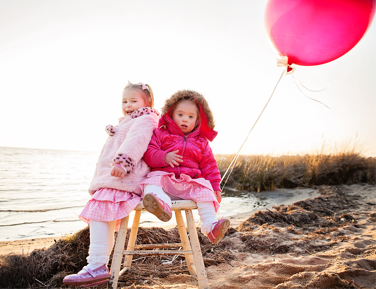 Sisters with pink balloon at Jockey's Ridge State park