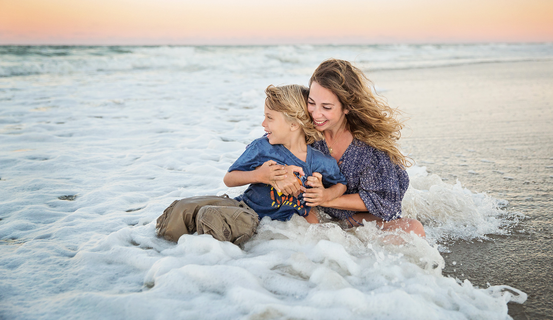 Mom and son playing in the ocean - lifestyle photography OBX