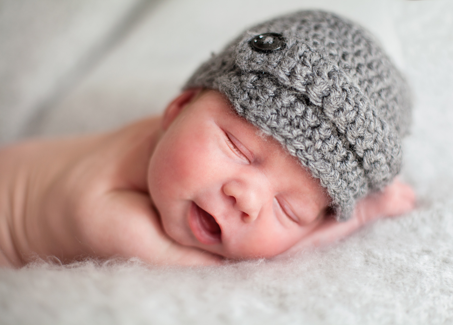 sweet newborn boy in a newsboy hat