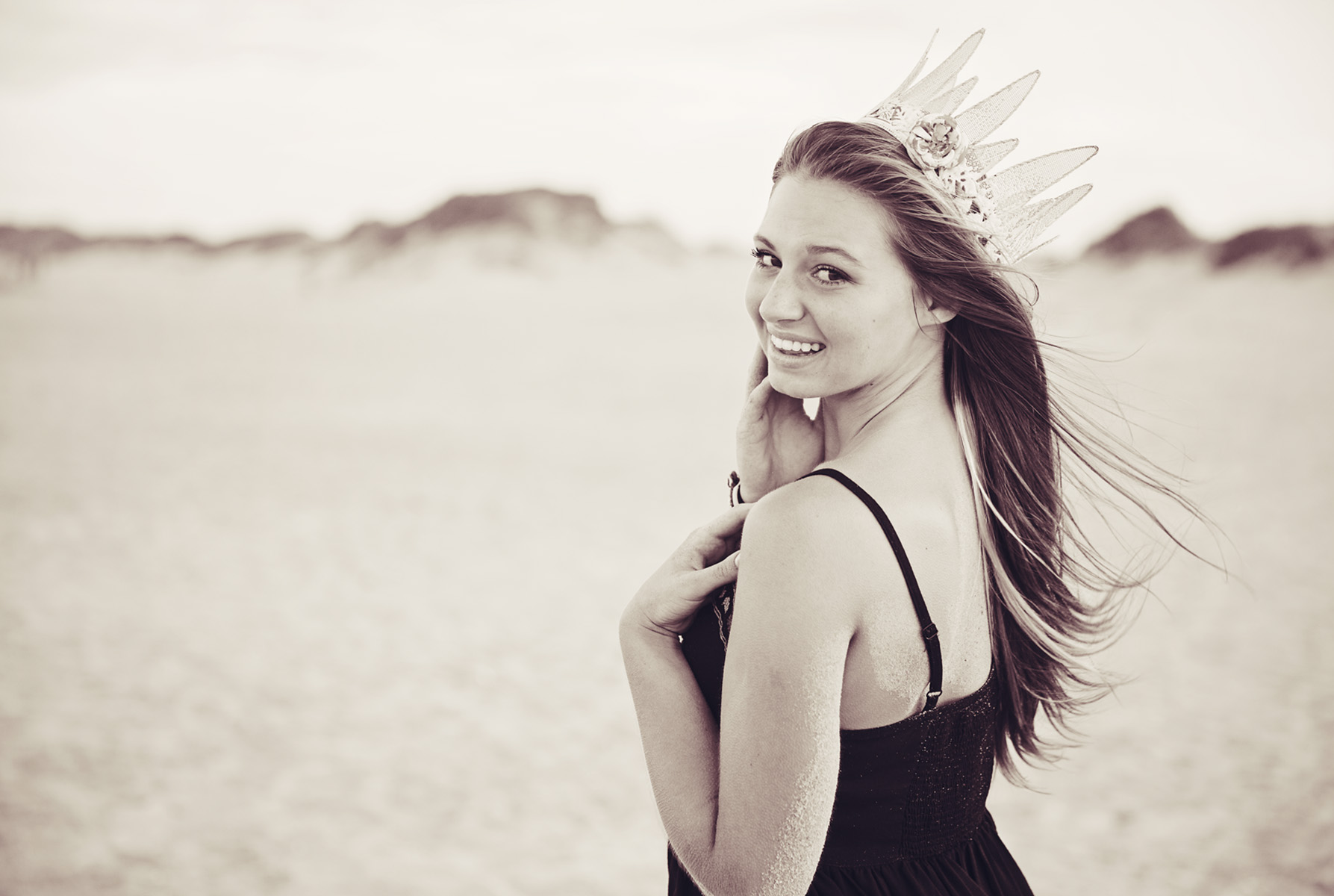 Senior girl with crown at the beach
