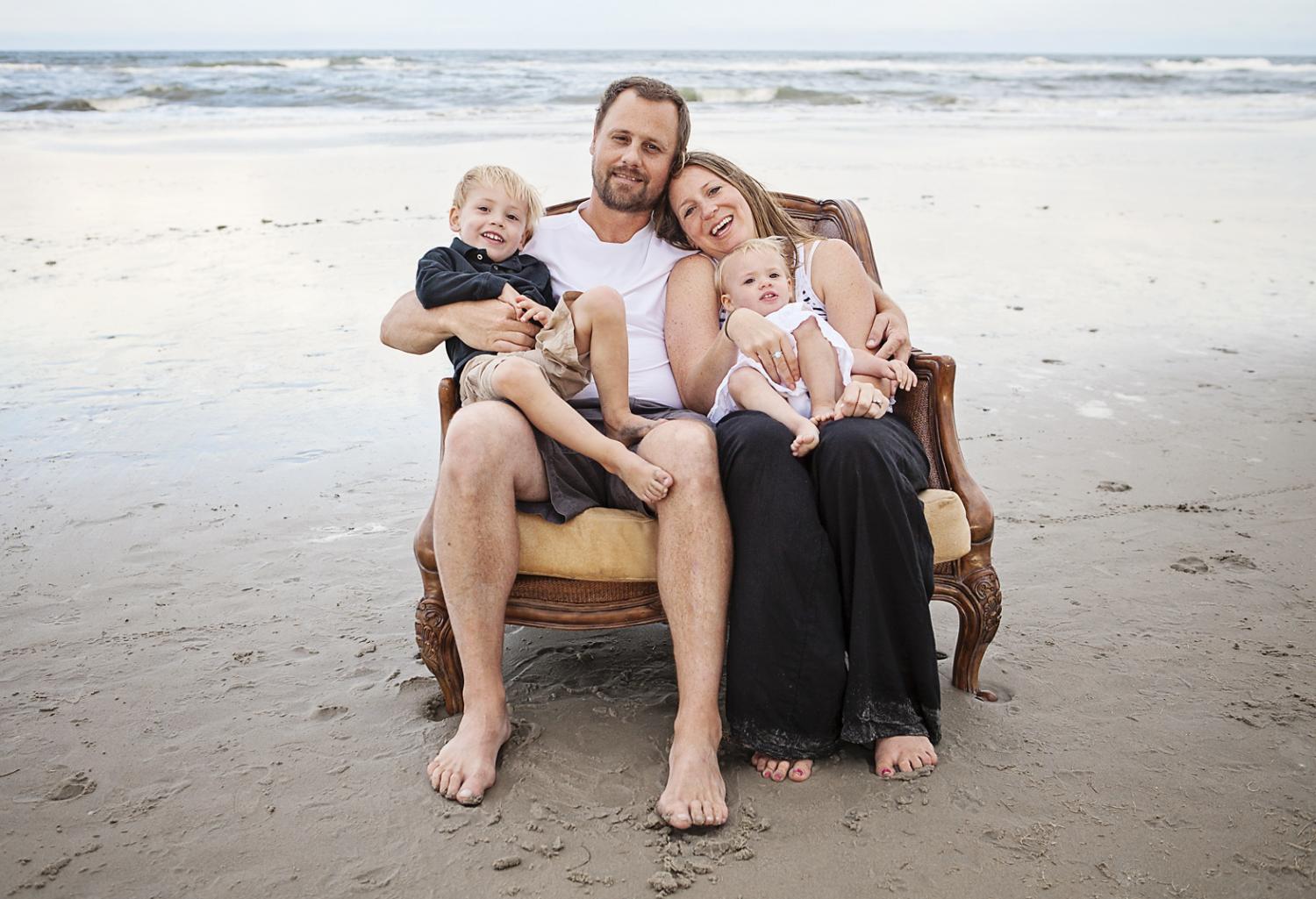 Family in a loveseat on the beach in Corolla NC