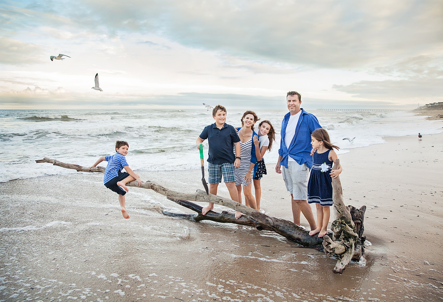 Fun family photo on driftwood on the beaches of Duck NC