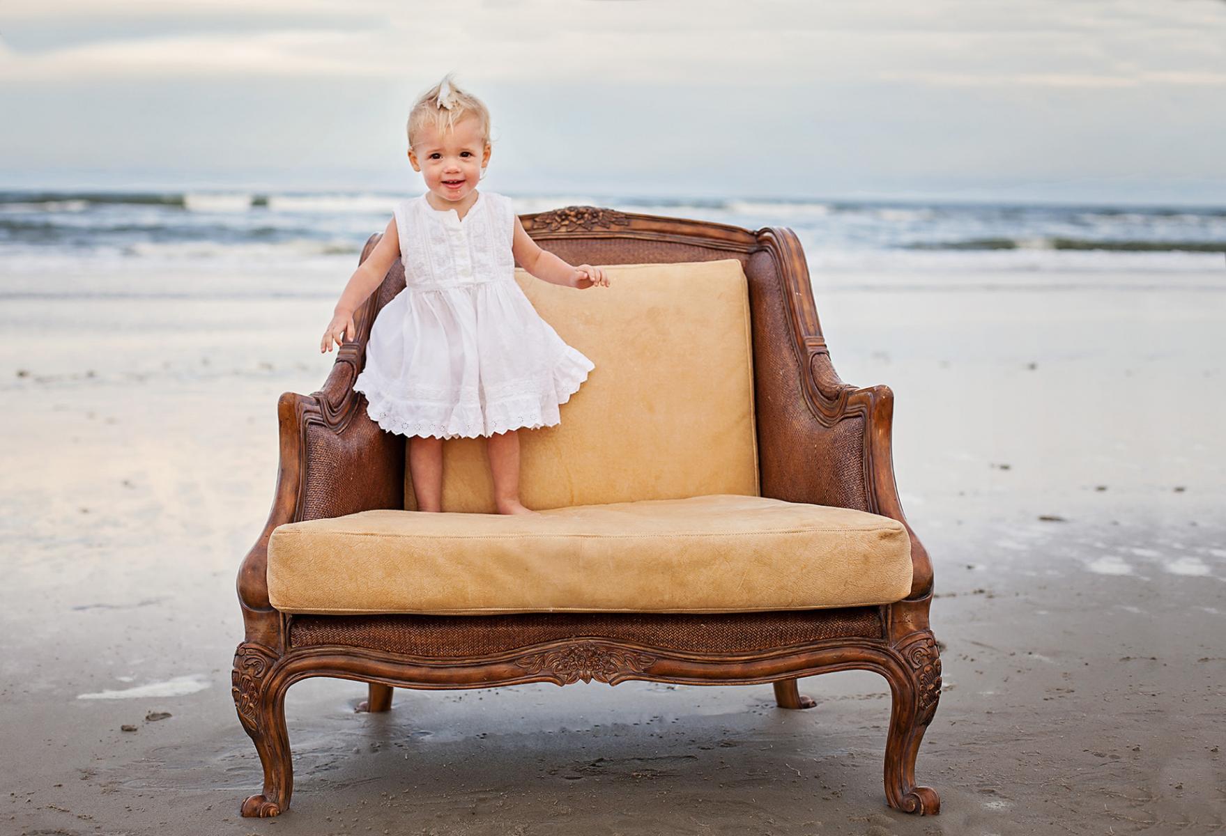 Sweet little girl photograph on chair at the beach Corolla NC